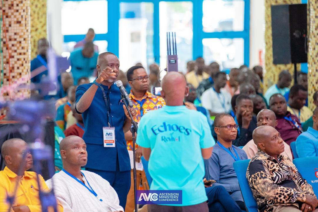 A conference attendee asks a question